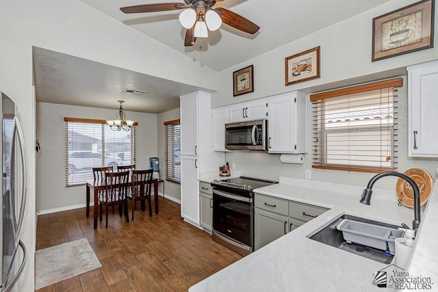 4452 S Agave Ave, Yuma, AZ 85365 - kitchen featuring stainless steel appliances, vaulted ceiling, light countertops, a chandelier, and a ceiling fan