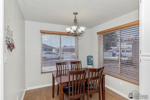 4452 S Agave Ave, Yuma, AZ 85365 - dining room featuring a chandelier, wood finished floors, and a textured ceiling