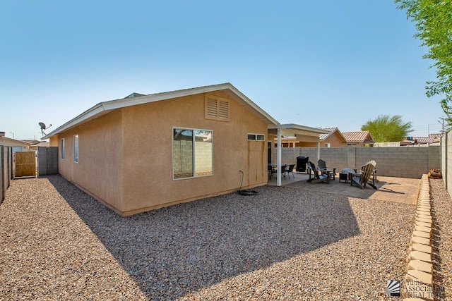 4452 S Agave Ave, Yuma, AZ 85365 - back of property with stucco siding, a fenced backyard, and a patio area