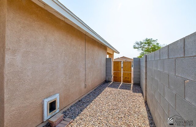 4452 S Agave Ave, Yuma, AZ 85365 - view of home's exterior with stucco siding and a gate