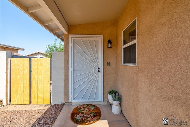 4452 S Agave Ave, Yuma, AZ 85365 - view of exterior entry featuring stucco siding and a gate