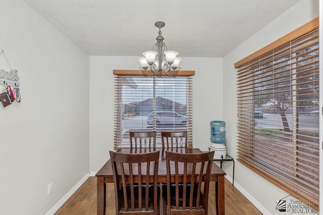 4452 S Agave Ave, Yuma, AZ 85365 - dining room with a chandelier, wood finished floors, and a textured ceiling