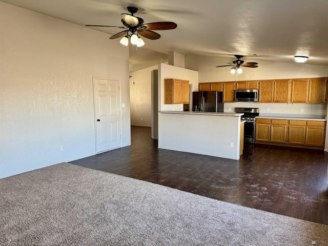 11278 E 24th Pl, Yuma, AZ 85367 - kitchen featuring ceiling fan, brown cabinetry, dark carpet, stainless steel appliances, and lofted ceiling