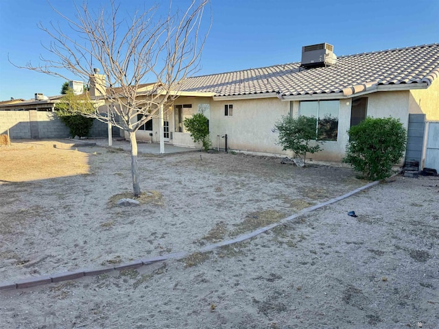 11278 E 24th Pl, Yuma, AZ 85367 - rear view of house featuring fence, central AC, stucco siding, a chimney, and a tiled roof