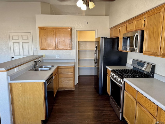11278 E 24th Pl, Yuma, AZ 85367 - kitchen with ceiling fan, a sink, stainless steel appliances, a peninsula, and dark wood-style floors