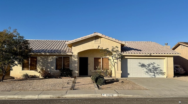11278 E 24th Pl, Yuma, AZ 85367 - ranch-style home with an attached garage, concrete driveway, stucco siding, and a tile roof