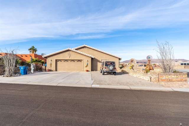 14530 E 55th St, Yuma, AZ 85367 - ranch-style home featuring concrete driveway, an attached garage, a tile roof, and stucco siding
