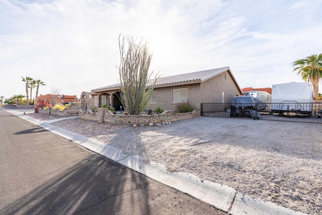 14530 E 55th St, Yuma, AZ 85367 - ranch-style home with fence, stucco siding, gravel driveway, and a tiled roof