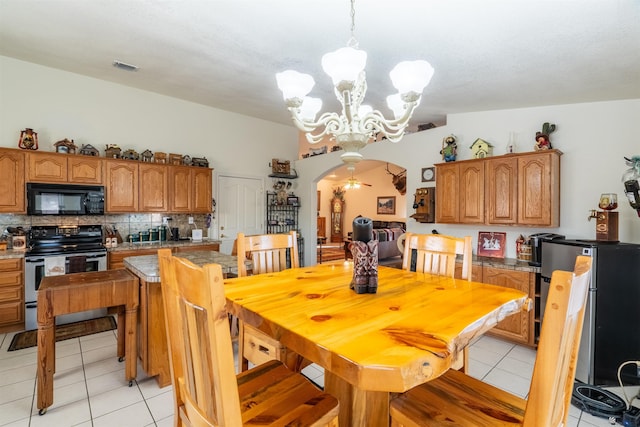 14530 E 55th St, Yuma, AZ 85367 - dining area featuring arched walkways, an inviting chandelier, light tile patterned floors, and visible vents