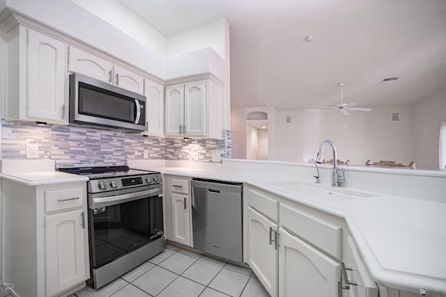 13779 E 54th Dr, Yuma, AZ 85367 - kitchen featuring a sink, stainless steel appliances, a ceiling fan, light tile patterned floors, and tasteful backsplash