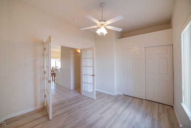 13779 E 54th Dr, Yuma, AZ 85367 - unfurnished bedroom with ceiling fan, french doors, baseboards, a closet, and light wood-style flooring