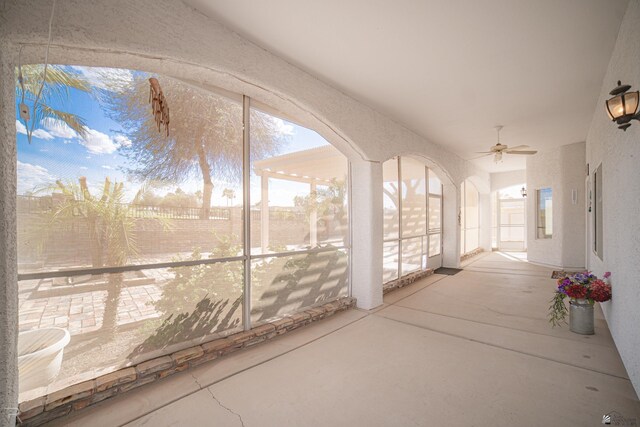 13779 E 54th Dr, Yuma, AZ 85367 - unfurnished sunroom featuring arched walkways and plenty of natural light