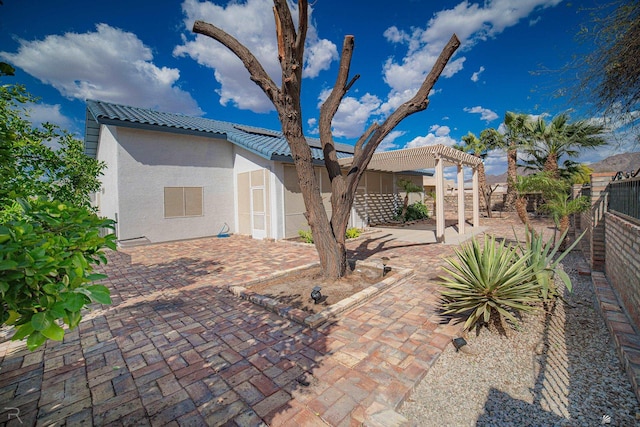 13779 E 54th Dr, Yuma, AZ 85367 - rear view of house with a tile roof, a patio area, fence, a pergola, and stucco siding