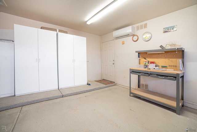 13779 E 54th Dr, Yuma, AZ 85367 - interior space with visible vents, concrete floors, an AC wall unit, and a workshop area