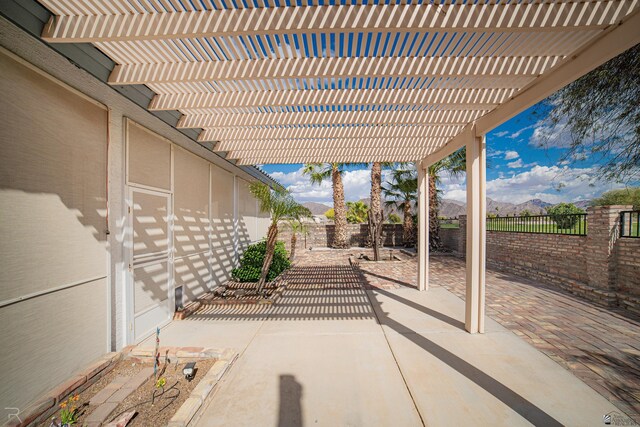 13779 E 54th Dr, Yuma, AZ 85367 - view of patio with a fenced backyard, a mountain view, and a pergola