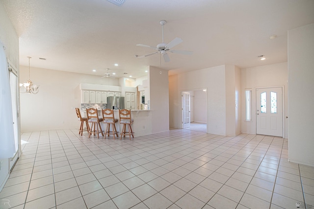 13779 E 54th Dr, Yuma, AZ 85367 - living room with recessed lighting, ceiling fan with notable chandelier, and light tile patterned flooring
