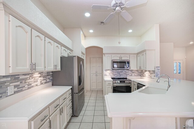 13779 E 54th Dr, Yuma, AZ 85367 - kitchen featuring a peninsula, light tile patterned flooring, ceiling fan, a sink, and stainless steel appliances