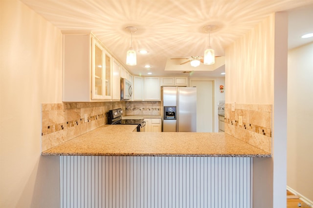 12402 E Via Estrella, Yuma, AZ 85367 - kitchen with appliances with stainless steel finishes, decorative backsplash, glass insert cabinets, recessed lighting, and light stone counters