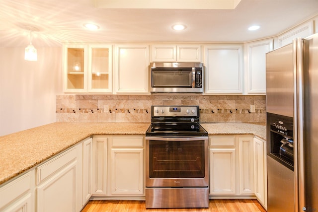 12402 E Via Estrella, Yuma, AZ 85367 - kitchen featuring stainless steel appliances, light stone counters, decorative backsplash, and recessed lighting