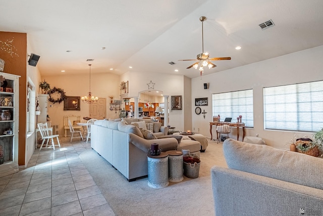 living room with tile patterned flooring, ceiling fan with notable chandelier, and lofted ceiling