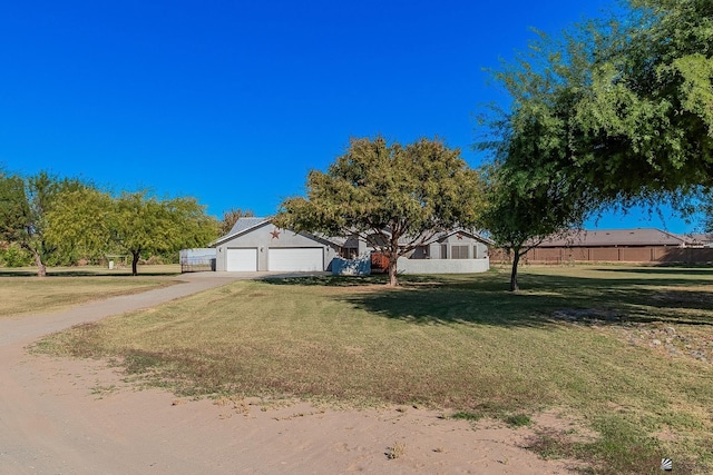 view of front facade with a front yard and a garage