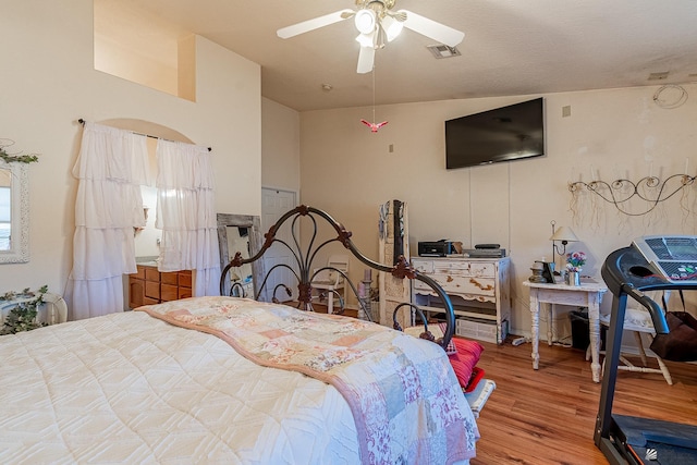 bedroom featuring ceiling fan, vaulted ceiling, and hardwood / wood-style flooring