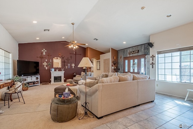 tiled living room featuring ceiling fan and vaulted ceiling