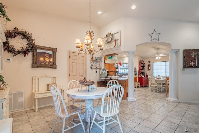 tiled dining room with ceiling fan with notable chandelier and lofted ceiling