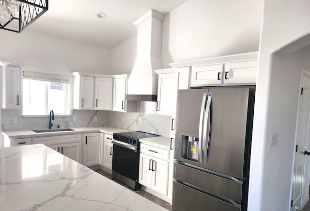 kitchen featuring sink, stainless steel fridge with ice dispenser, electric range, light stone countertops, and white cabinets