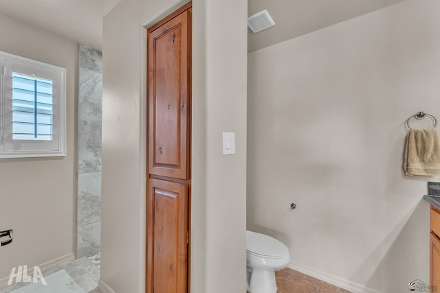 bathroom with tile patterned flooring, visible vents, baseboards, toilet, and vanity