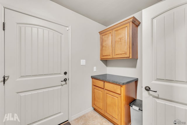 clothes washing area featuring baseboards