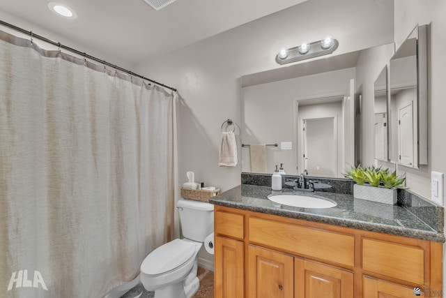 bathroom featuring visible vents, toilet, and vanity