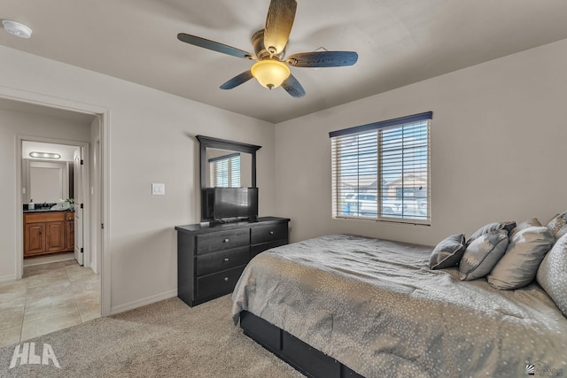 bedroom with light tile patterned floors, light colored carpet, baseboards, and ceiling fan