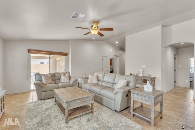 living area with visible vents, vaulted ceiling, light tile patterned flooring, arched walkways, and a ceiling fan