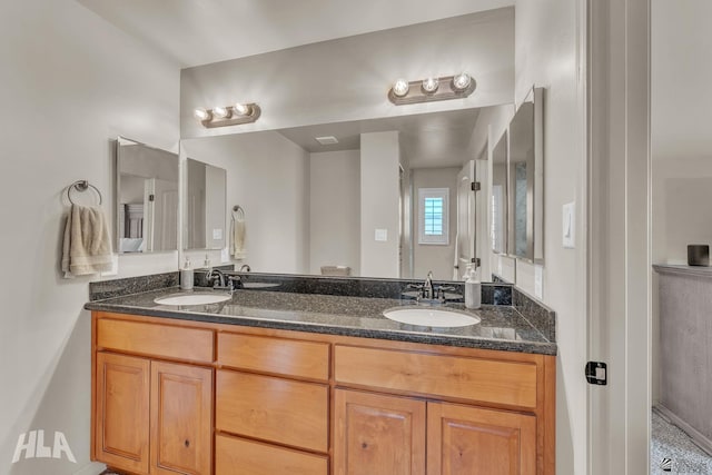 full bathroom featuring double vanity and a sink