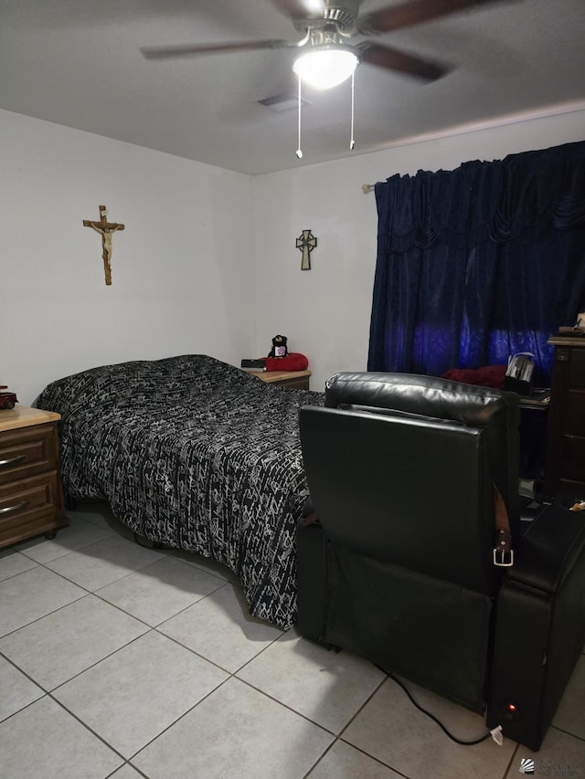 tiled bedroom featuring ceiling fan