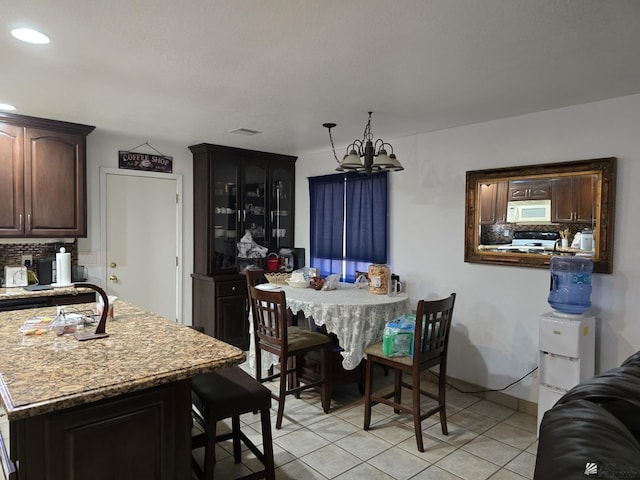 dining room featuring light tile patterned floors and an inviting chandelier