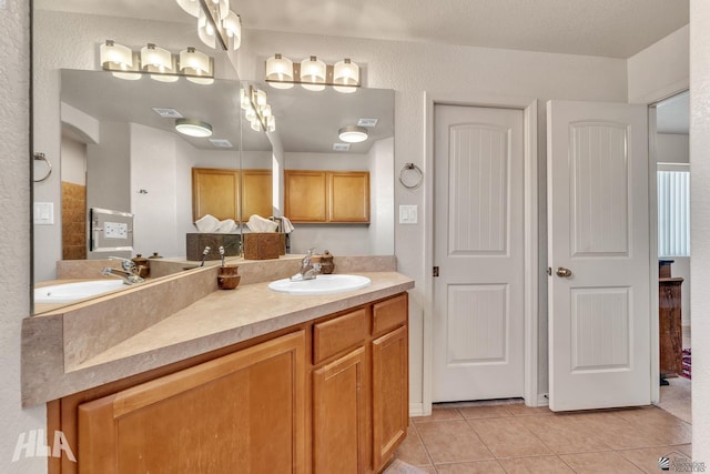 bathroom with tile patterned flooring and vanity