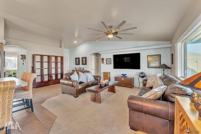 tiled living room featuring lofted ceiling and ceiling fan