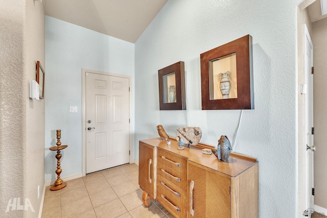 entryway with light tile patterned flooring