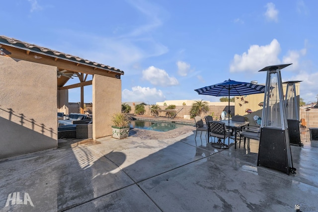 view of patio with a fenced in pool and ceiling fan