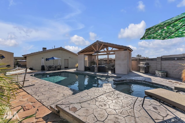 view of swimming pool with a grill, a gazebo, a patio, and an in ground hot tub