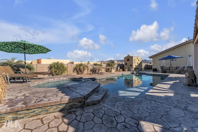 view of swimming pool with a patio and an in ground hot tub