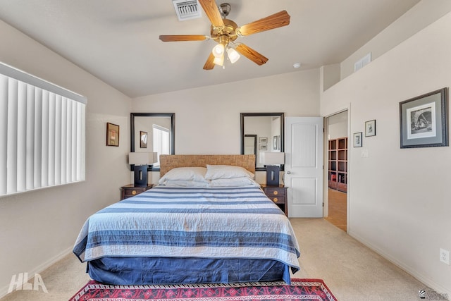 bedroom with lofted ceiling, light colored carpet, and ceiling fan