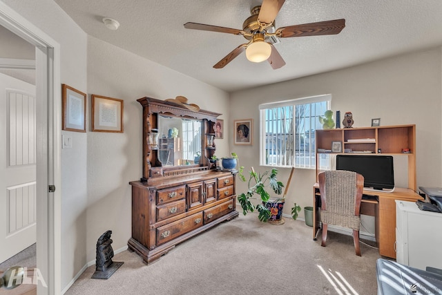 office area with ceiling fan, light carpet, and a textured ceiling