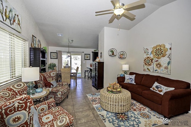 living room featuring ceiling fan, light tile patterned floors, and lofted ceiling