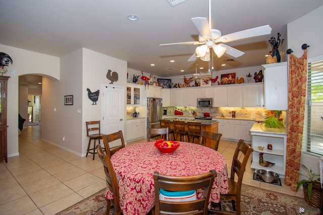 tiled dining area with ceiling fan