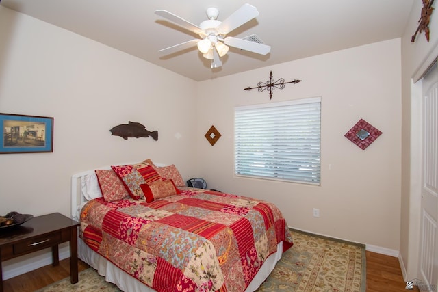 bedroom with hardwood / wood-style floors and ceiling fan