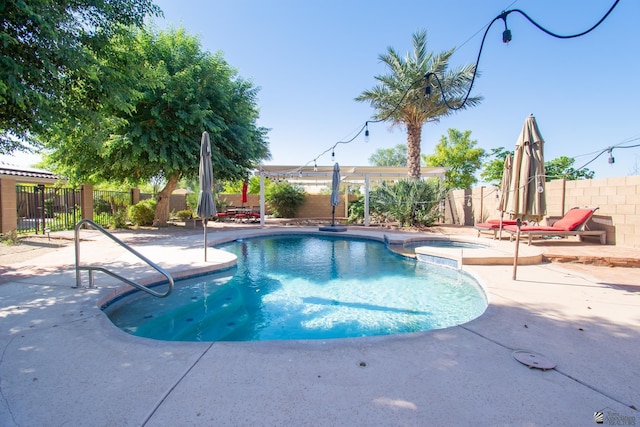 view of swimming pool featuring an in ground hot tub and a patio