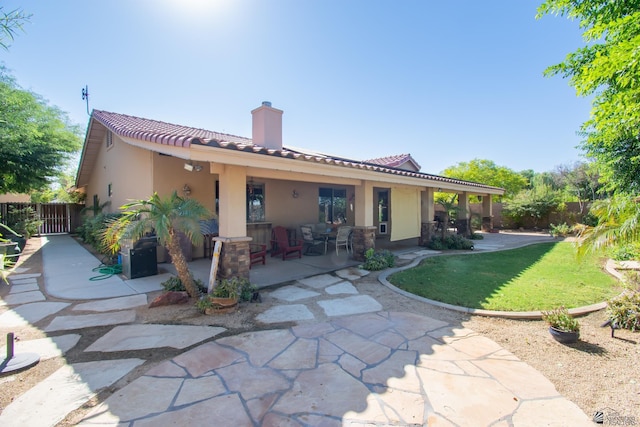 back of property with a patio